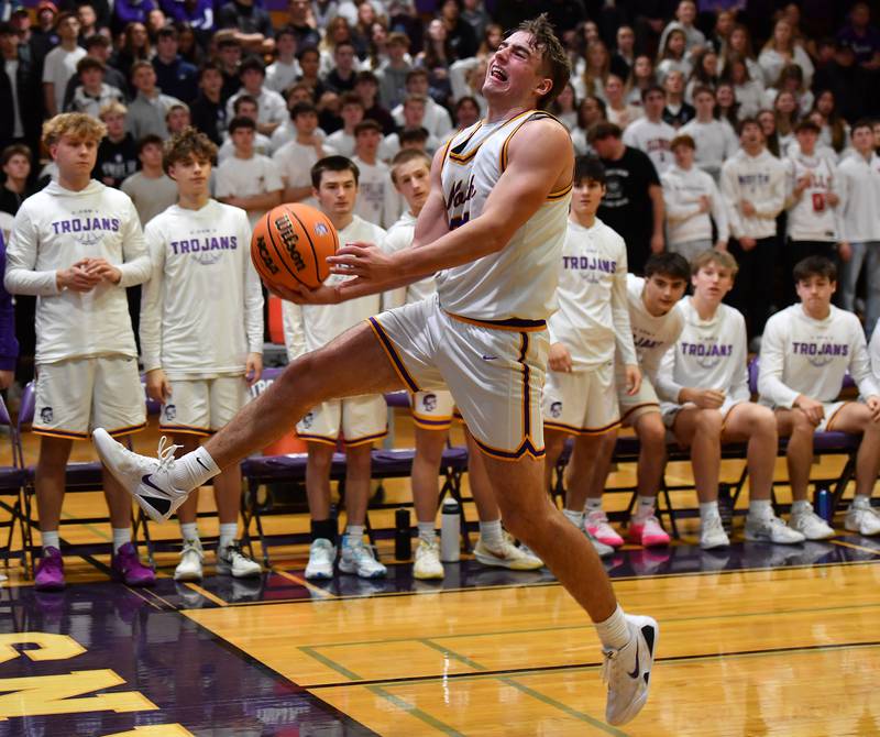 Downers Grove North’s Jacob Vroman starts an airborne over the shoulder pass as he saves the ball from going out of bounds during a game against Downers Grove South on December 20, 2025 at Downers Grove North High School in Downers Grove.