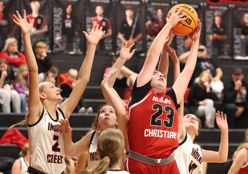 Aurora Christian’s Kate Taylor grabs a rebound between three Indian Creek players during their game Monday, Nov. 25, 2024, at Indian Creek High School in Shabbona.