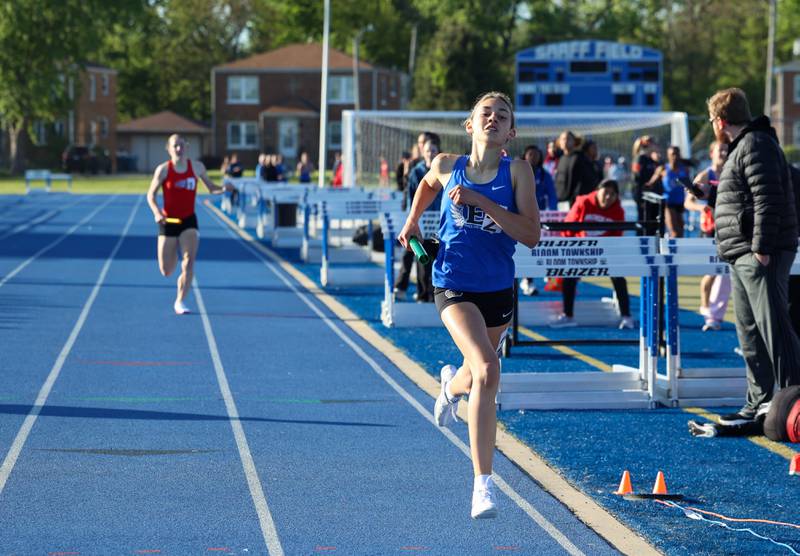 Lincoln-Way East's runner approaches the finish line in first place in the 4x800 relay during the IHSA Class 3A Chicago Heights Girls Track and Field Sectional at Bloom High School on Wednesday, May 13, 2026.