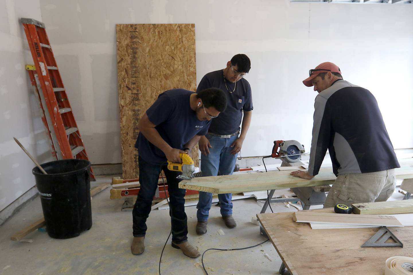 Teacher Erich Parpart watches as Erik Moctezuma and Jose Campos, both seniors in the Woodstock Building Trades Program, cut out stair stringers as they work Monday, May 8, 2023. The students are building a home in Woodstock. This will be the program’s 43rd completed home since it began in 1972.
