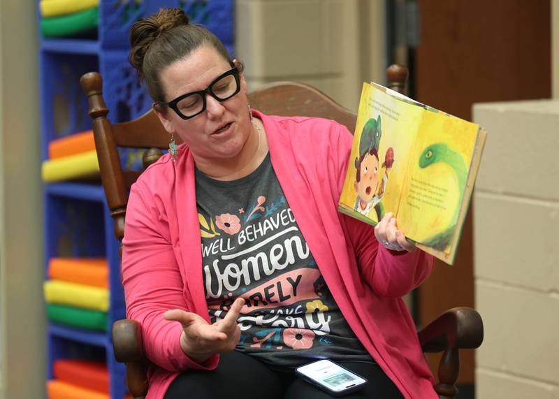 Cortland Elementary School librarian/media assistant Leslie Leahy reads a book to fourth graders Tuesday, March 31, 2026 in the library at the school.