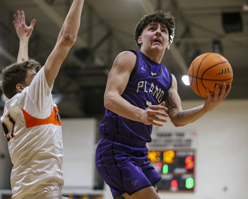 Plano's Ethan Taxis (3) hangs in the air while he puts up a shot during their basketball game between Sandwich at Plano Tuesday, Jan 27, 2026 in Sandwich.