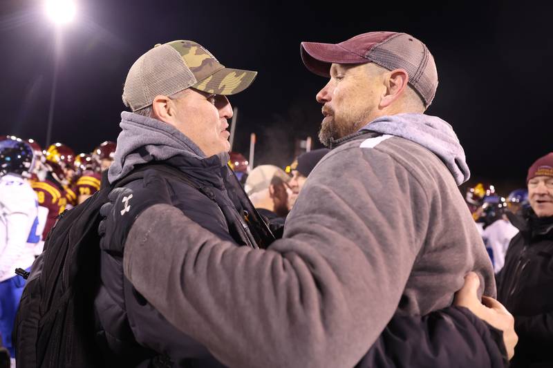 Pat Fitzgerald congratulates Loyola head coach Beau Desherow after the Ramblers’ 26-15 win over Lincoln-Way East in the Class 8A championship on Saturday, Nov. 25, 2023 at Hancock Stadium in Normal.