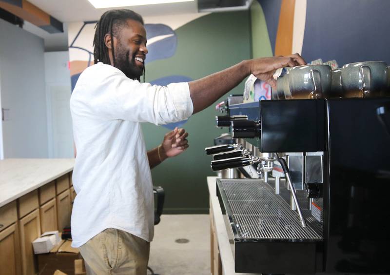 Troy Rorer, owner of The Greenhouse with his wife Kailey, sets up their new coffee area Thursday, Feb. 29, 2024, at the store in Sycamore. The Greenhouse has expanded in size and will soon offer new services.