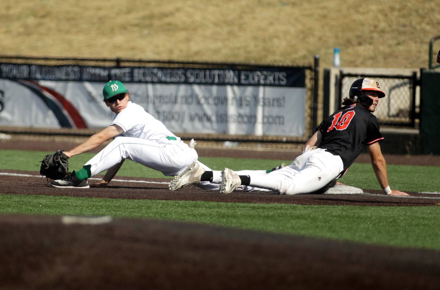 York’s Jack Braun (left) stretches for the catch at first as Edwardsville’s Andrew Hendrickson slides during a Class 4A state semifinal game at Duly Health and Care Field in Joliet on Friday, June 9, 2023.