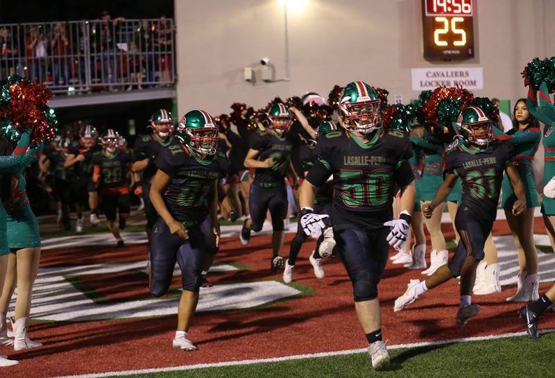 Members of the L-P football team run through the tunnel to play Ottawa on Friday, Oct. 3, 2025 at Howard Fellows Stadium.