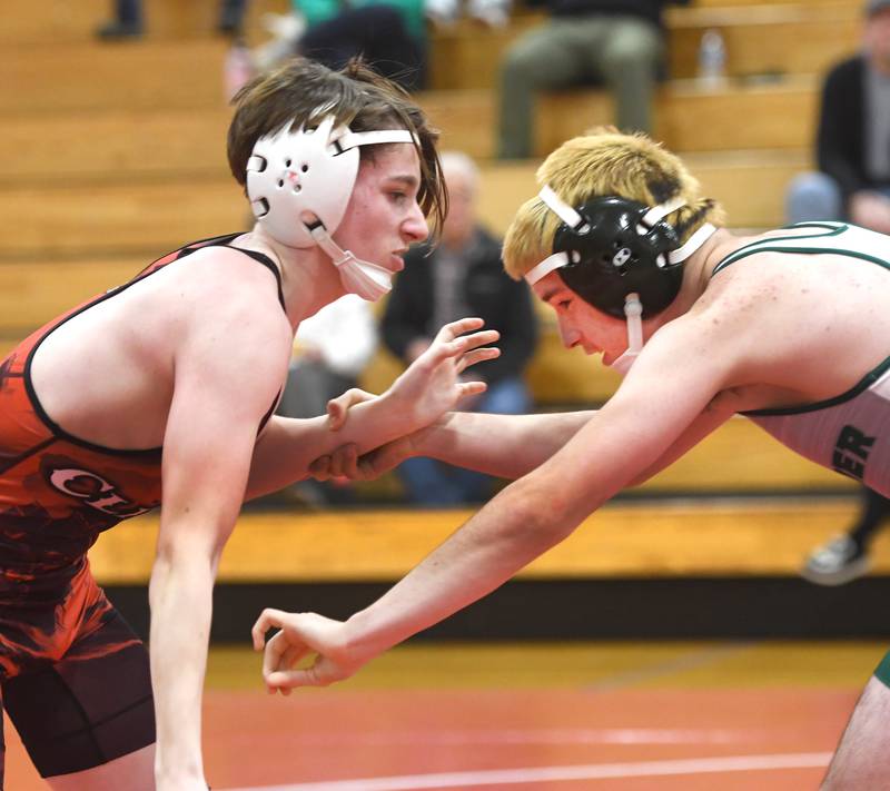 Amboy's Chase Huggins (left) and West Carroll's Adel Foley begin their 126 pound match at Oregon High School on Tuesday, Nov. 25, 2025.