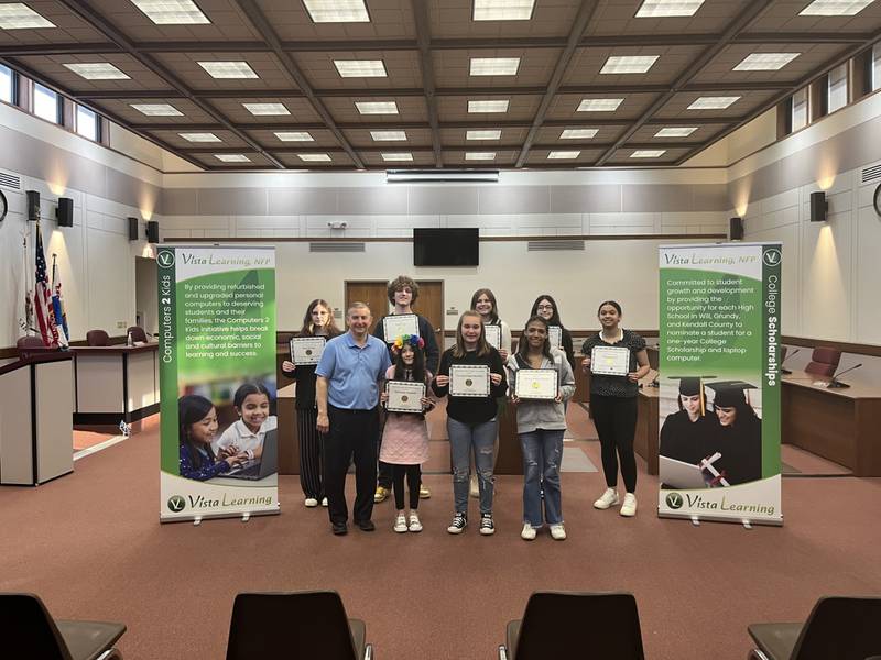 Students met with Vista Learning at the Grundy County Awards Ceremony. The adult on the left is Chris Mehochko, Regional Superintendent of the Regional Office of Education for Grundy and Kendall Counties .