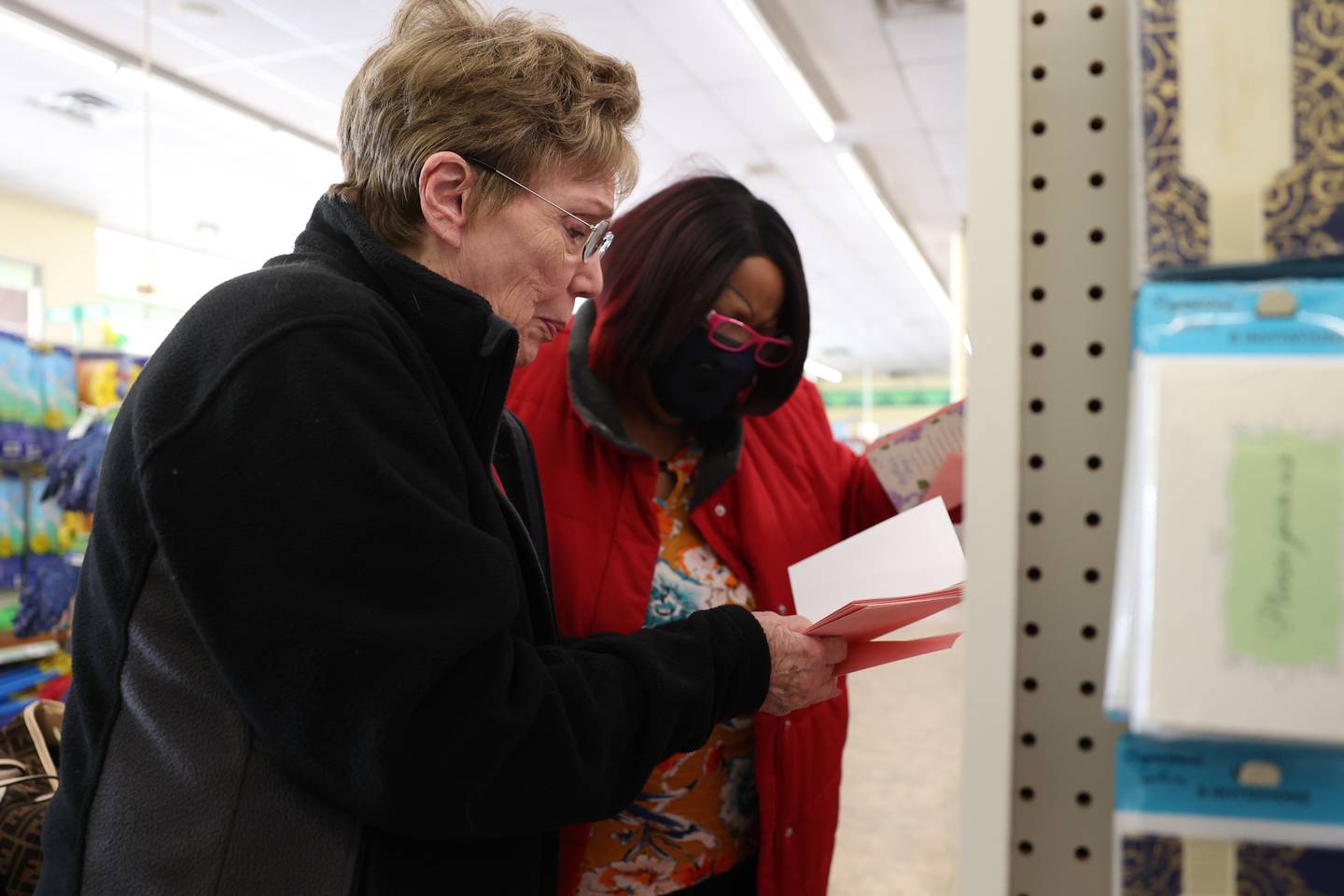 Senior Companion volunteer Karen Stromberger, left, helps Josephine Simmons pick out Mother’s Day cards for members at Josephine’s church at a nearby store. Catholic Charities Senior Companion Program offers adults age 55 and older the opportunity to support and interact with their homebound peers. Wednesday, April 27, 2022, in Crest Hill.