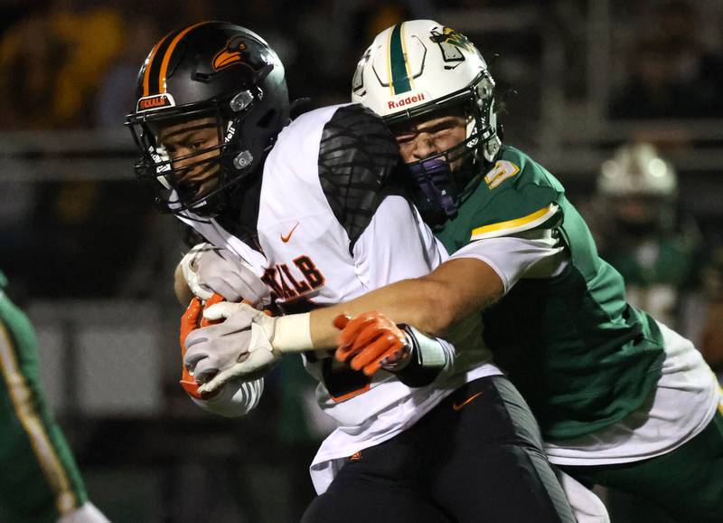 DeKalb's Billy Miller is wrapped up by Waubonsie Valley’s Owen Roberts during their game Friday, Oct. 11, 2024, at Waubonsie Valley High School in Aurora.