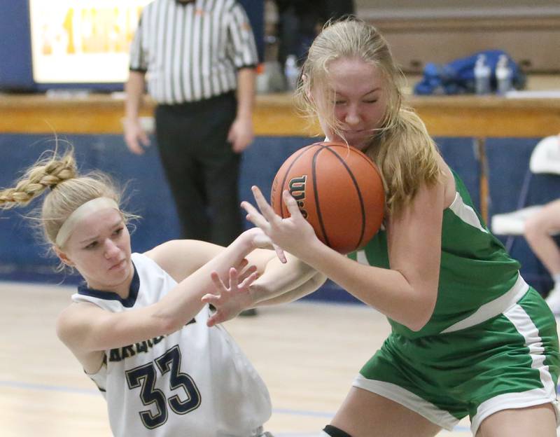 Marquette's Keely Nelson looses control of the ball as Seneca's Ella Sterling picks it up in Bader Gym on Monday, Jan. 23, 2023 at Marquette High School.