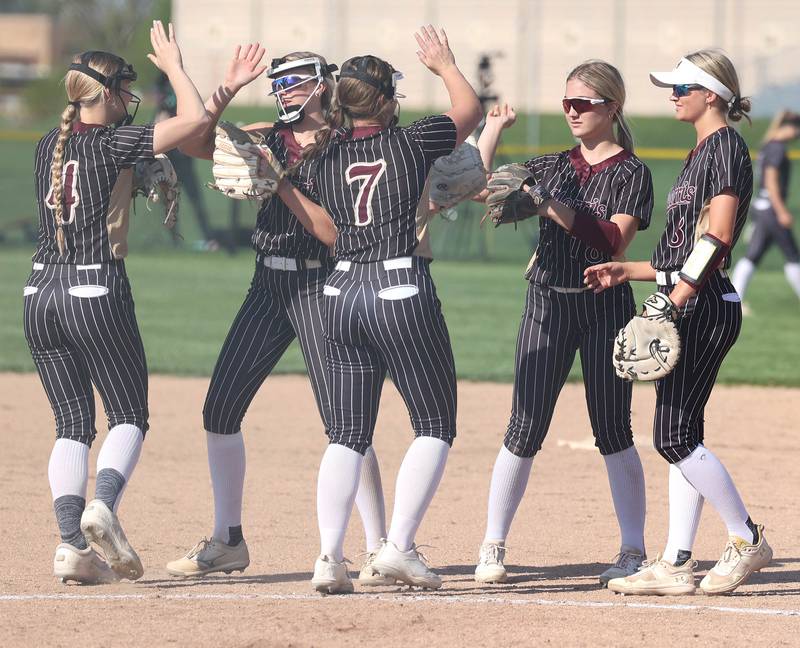 The Morris infield meets in the circle after recording an out during their game against Sycamore Wednesday, May 10, 2023, at Sycamore High School.