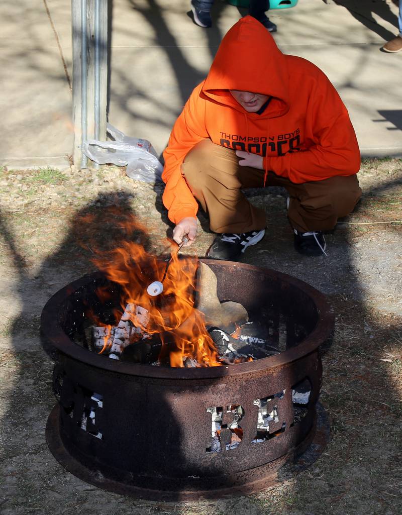 Aiden Toutan, 14, roasts a marshmallow for a s’more at the Kendall County Historical Society’s Annual Christmas at the Lyon Farm on Sunday, Dec. 8, 2024 in Yorkville.