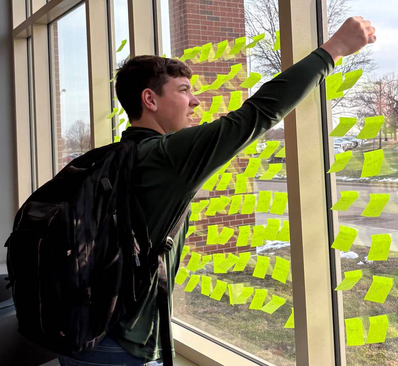 St. Bede Academy freshman Connor Holly adds his name to the "Bruin Impact Wall" after donating to the St. Benedict’s Day campaign on March 21, 2025. Holly was one of hundreds of students who took part in giving back during the campaign.
