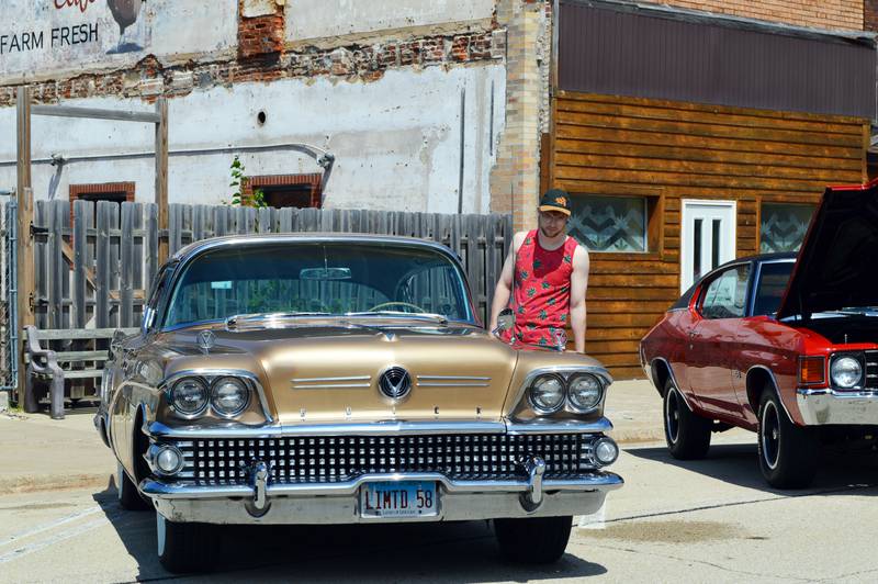 Jon Heath, of Polo, looks at a 1958 Buick Limited owned by Bill Kubik, of Woodridge, during the 33rd annual Polo Car Show on Aug. 13.
