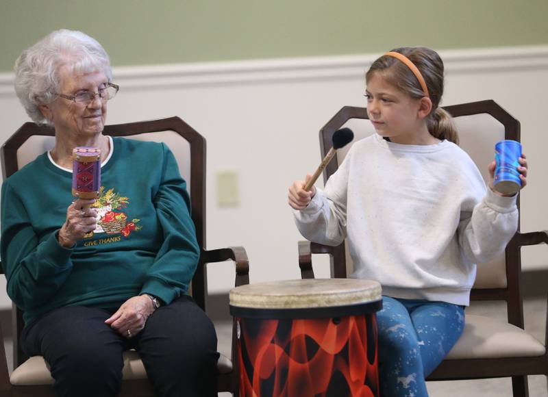 Greenfield resident Eunice Mcualey plays music with Lincoln Elementary School student Hadley Eckard during a drum circle on Friday, Oct. 17, 2025 at Greenfield Retirement Home in Princeton. The drum circle was hosted by Eric Swanson of Chicago, through his business Drum Impact. The students learned how to make rhythm, play instruments, music therapy, collaboration and converse with the residents.