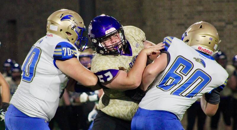 Dixon lineman Kit Wedekind (52) breaks through the Rockford Christian line on Friday.