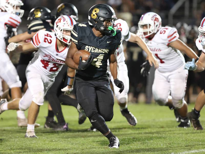 Sycamore's Tyler Curtis breaks through the Ottawa defensive line during their game Friday, Sept. 16, 2022, at Sycamore High School.