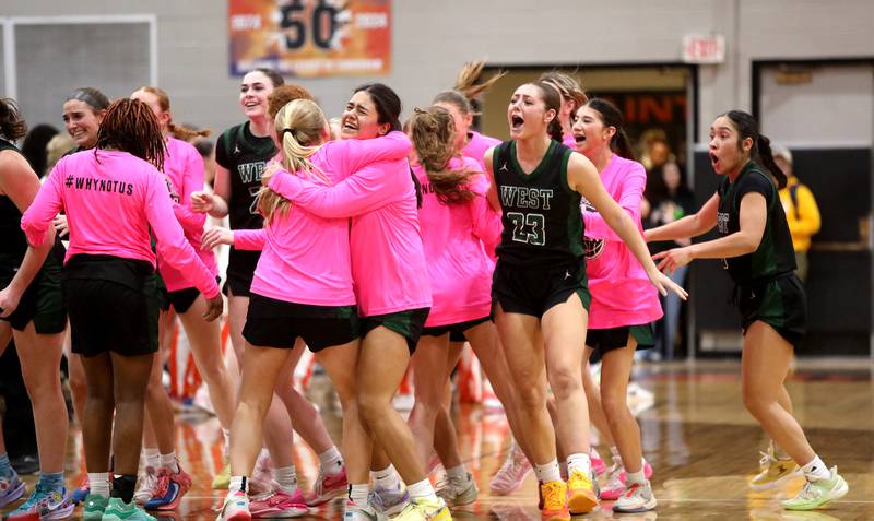 Glenbard West players celebrate their Class 4A St. Charles East Sectional semifinal win against St. Charles East on Tuesday, Feb. 25, 2025 in St. Charles.