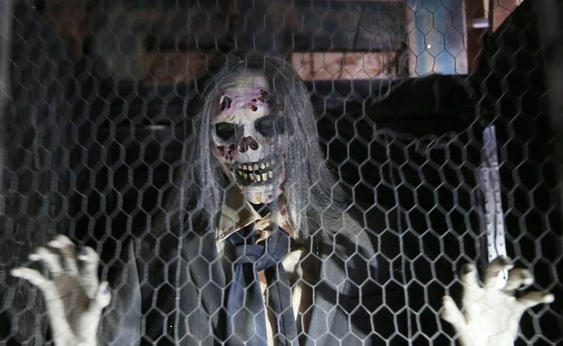 An animatronic masked creature pushes on a fence during the Nightmare on Fairgrounds Road Haunted Attraction on Wednesday, Sept. 25, 2024 at the Bureau County Fairgrounds in Princeton.