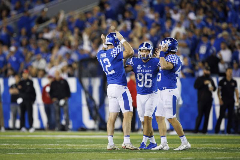Kentucky place kicker Chance Poore (12), place kicker Matt Ruffolo (96) and defensive tackle Richard Bascom (64) high five after a made field goal during an NCAA college football game against Northern Illinois in Lexington, Ky., Saturday, Sept. 24, 2022. (AP Photo/Michael Clubb)