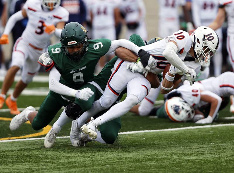 Oswego's Mariano Velasco (10) is brought down by the Lane Tech defense during the varsity football second-round 8A playoff game between Oswego and Lane Tech on Saturday, Nov. 8, 2025 in Chicago.