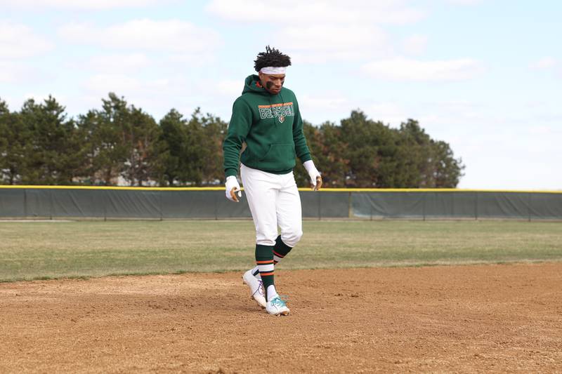 Plainfield East’s Christian Mitchelle tests the condition of the field before the game against Downers Grove North. Friday, April 1, 2022, in Plainfield.