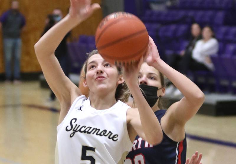 Sycamore's Faith Feuerbach shoots in front of Belvidere North's Grace Ulferts during their IHSA regional final game Thursday, Feb. 17, 2022, at Rochelle High School.