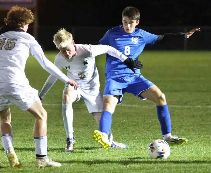 Sycamore's Paxton Nicol (left) and Burlington Central’s Stefano Amato fight for possession Tuesday, Oct. 21, 2025, during their IHSA Class 2A regional semifinal match at Burlington Central High School.