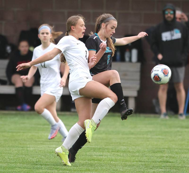 Sycamore's Anna Lochbaum and Woodstock North's Abby Foster go after the ball during their IHSA Class 2A regional game Tuesday, May 17, 2022, at Burlington Central High School.