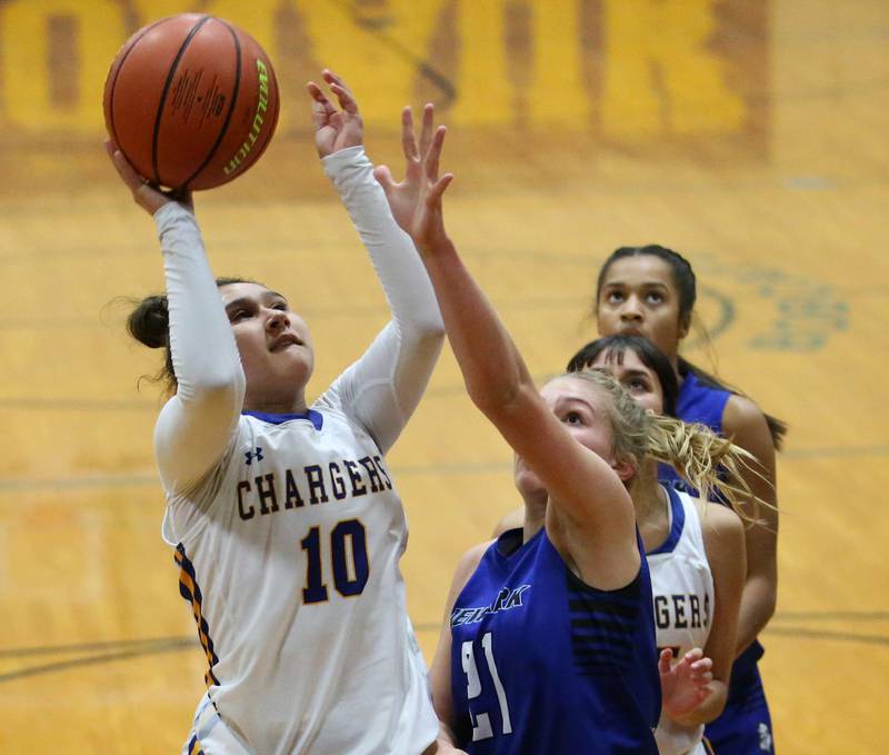 Aurora Central Catholic's Anna Marie Godina (10) pulls up in the lane to shoot a basket over Newark's Addison Ness (21) in the Tim Humes Breakout Tournament on Friday, Nov. 18, 2022 in Somonauk.