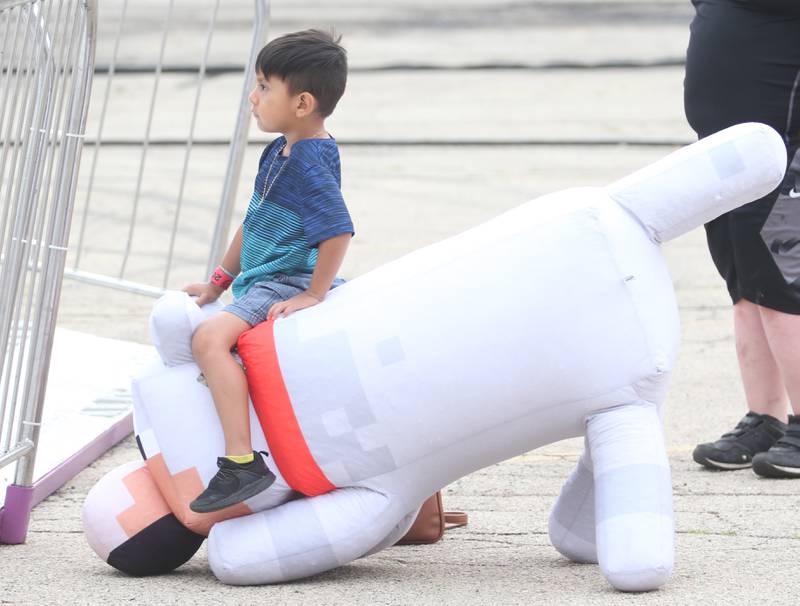 Moreno Sis of Spring Valley, rides a giant Minecraft inflatable dog that he won during the Peru Mall Carnival on Monday, June 26, 2023.