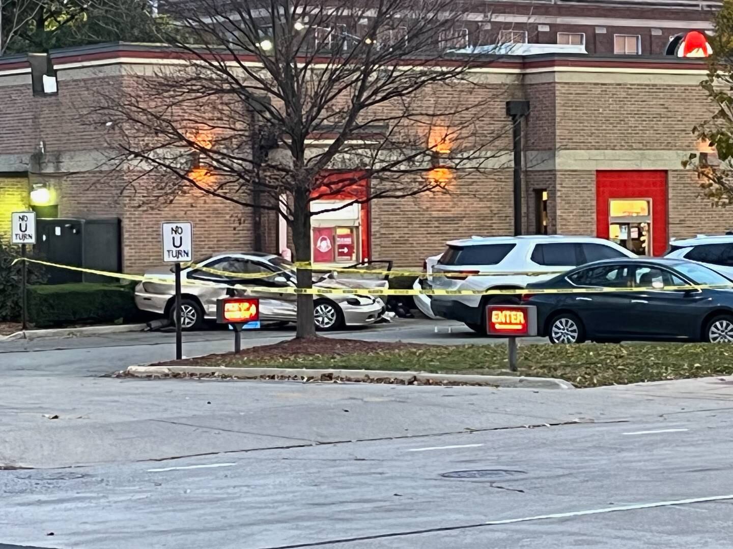 A damaged vehicle outside the Wendy's at West Jefferson and Center streets in the aftermath of an incident that left a Joliet police officer injured.