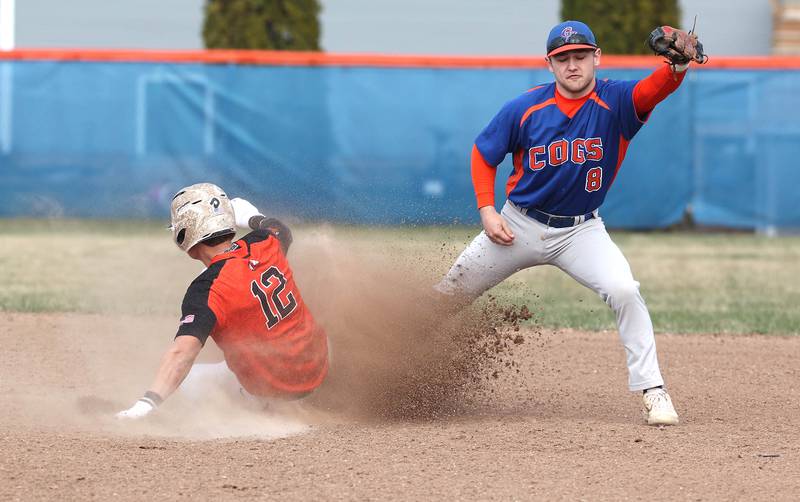 Genoa-Kingston's Nolan Perry tries to get Winnebago's Logan Watson at second base during their game Tuesday, April 12, 2022, at Genoa-Kingston High School.
