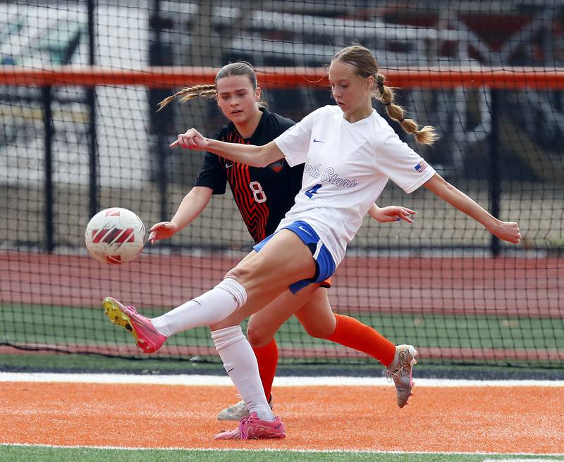 St. Charles North's Kaitlyn Nudera (4) passes the ball around St. Charles East's Georgia Smith (8) during the championship game of the Rose Augsburg Drach Invitational Saturday, March 29, 2025 in St. Charles Ill.