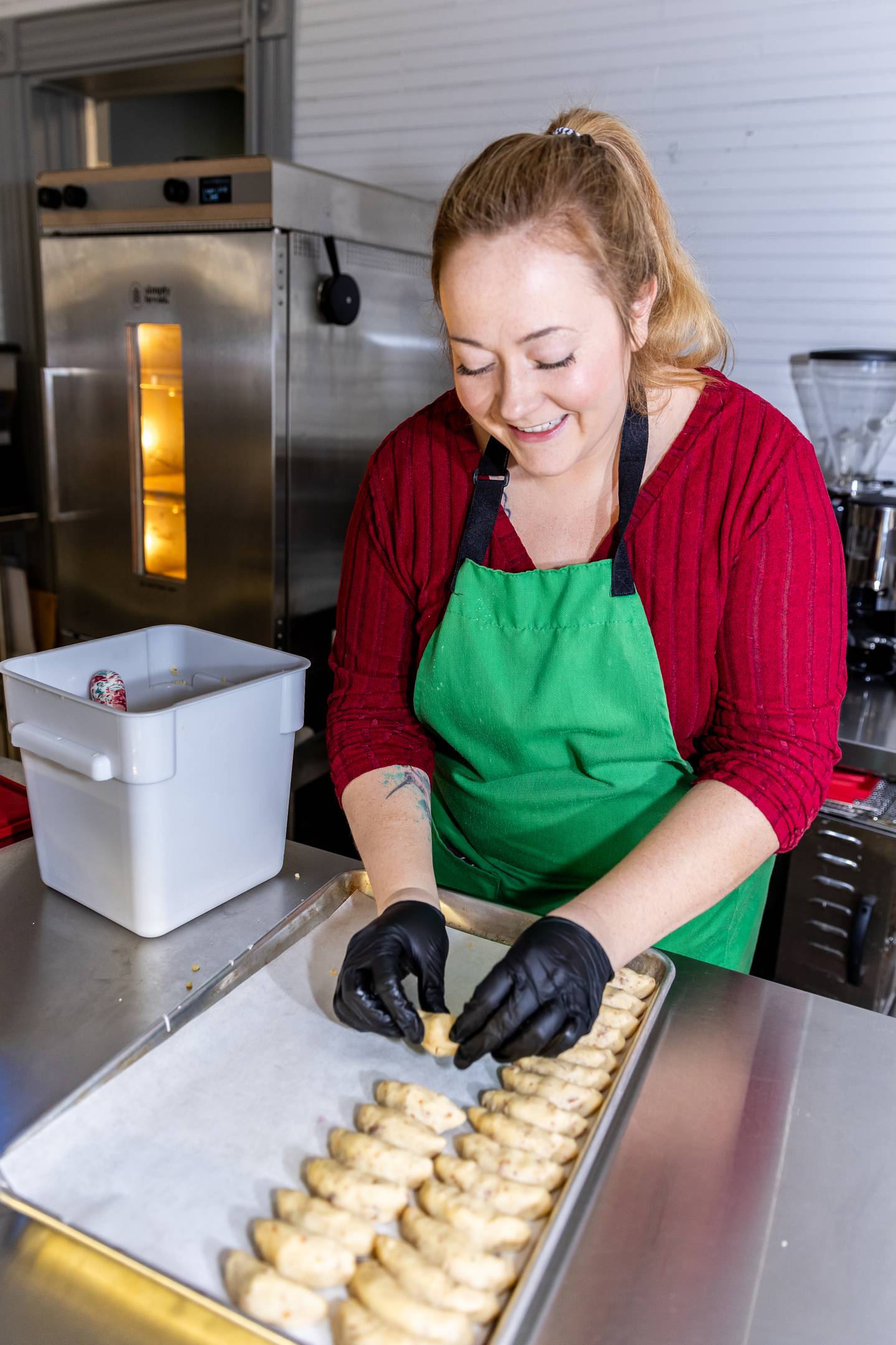 Nicola's Heavenly Cucina staff member, Angel Rolla, prepares almond crescent cookies on Dec. 18, 2024.