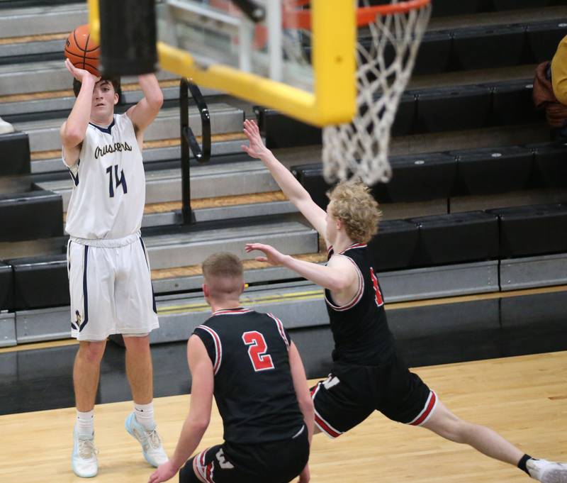 Marquette's Carson Zellers shoots a jump shot over Woodland's Jon Moore and Connor Dodge during the Tri-County Conference Tournament on Thursday, Jan. 25, 2024 at Putnam County High School.