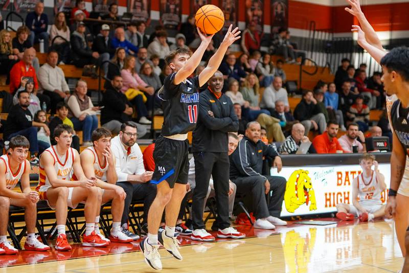 Marmion’s Benjamin Piekarz (11) shoots a three-pointer against Batavia during a game at Batavia High School on Wednesday, Nov. 26, 2025.