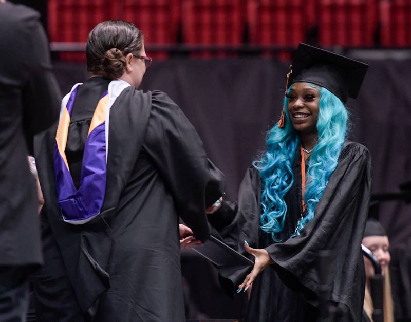 Demittria Halmon receives her diploma during the DeKalb High School graduation ceremony at the Convocation Center in DeKalb on Saturday, May 28, 2022.