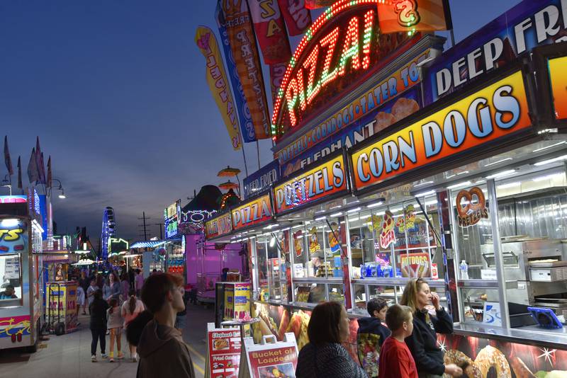 Carnival rides attract people to Liberty Drive at the Cream of Wheaton summer festival in downtown Wheaton on Thursday, May 30, 2024.