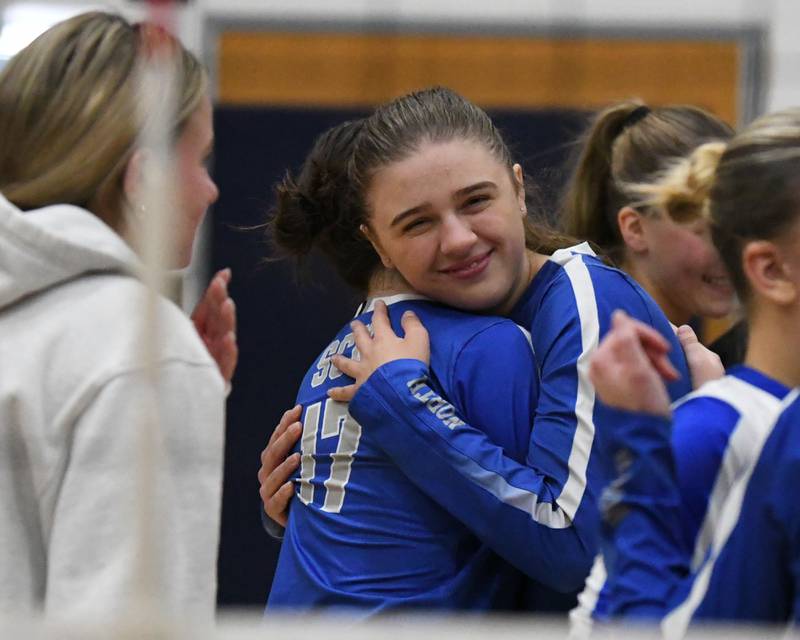 St. Charles North's Ava McDowell (26) gets a hug from teammate Addison Kashuba (17) after ending their season on Thursday Nov. 7, 2024, after dropping two games to Benet Academy in the 4A sectional title game held at West Aurora High School.