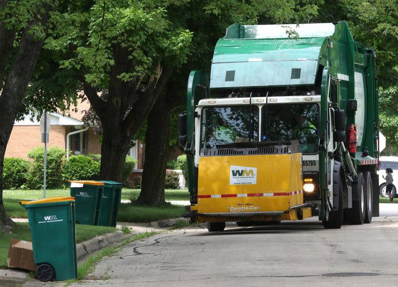 A Waste Management truck travels its route June 21 in DeKalb. Waste Management will end its tenure as DeKalb's trash hauler in this Shaw Local file photo.