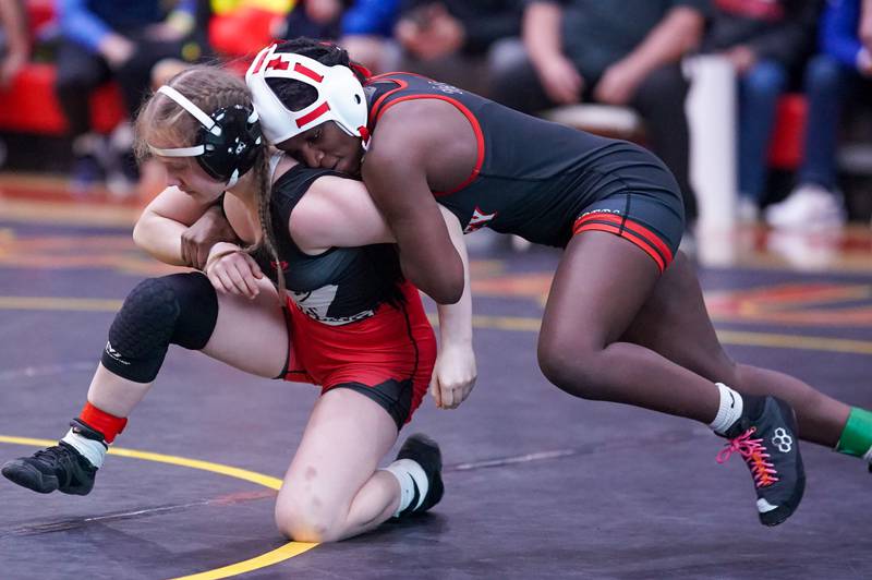 Huntley’s Janiah Slaughter (right) fights to keep top position over Glenbard East’s Nadiia Shymkiv during their 105 pound championship match in the Schaumburg Girls Wrestling Sectional at Schaumburg High School on Saturday, Feb 10, 2024.
