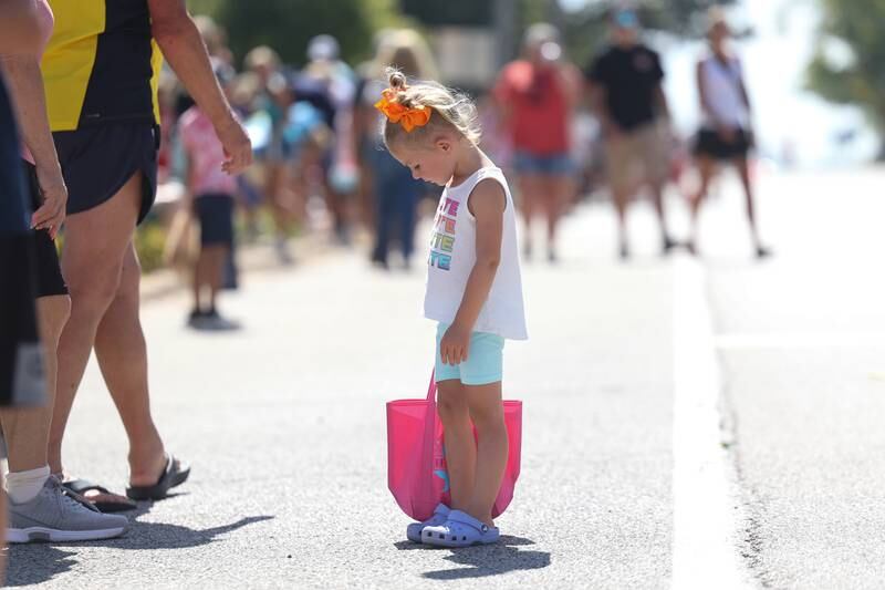 Felicity Taylor looks for more candy after the Manhattan Labor Day Parade on Monday, Sept. 4, 2023 in Manhattan.
