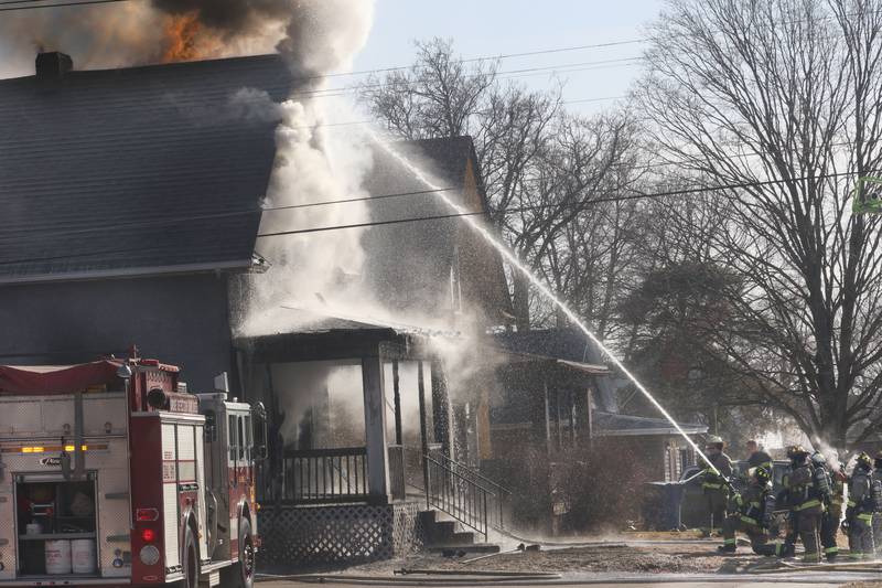 Flames work to extinguish flames during a structure fire in the 800 block of Bucklin Street on Friday, Jan. 23, 2026 in La Salle.