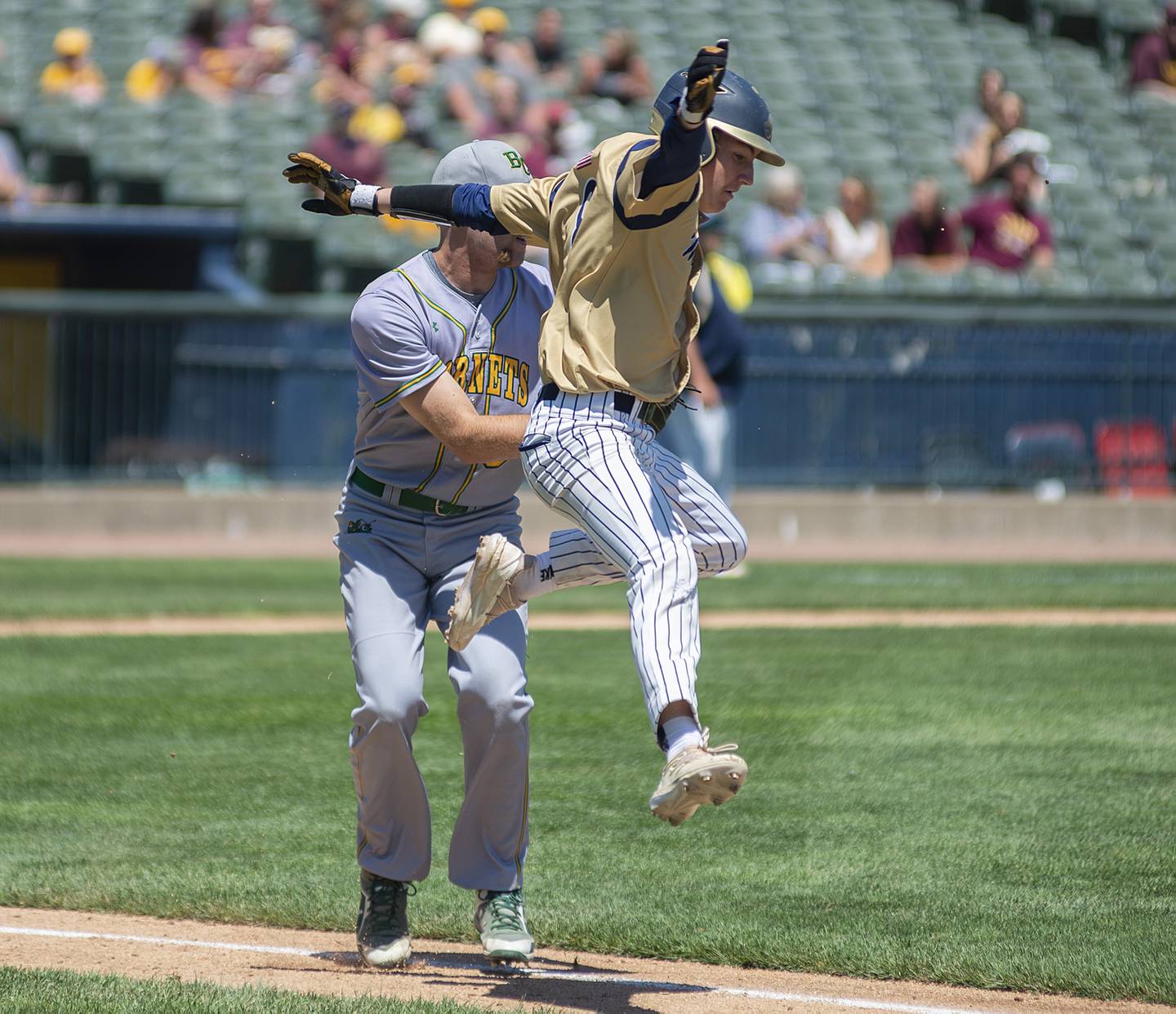 Ottawa-Marquette’s Carson Zellers tries to avoid a tag by Brown County pitcher Gabe Blakeley Friday, June 3, 2022 during the IHSA Class 1A baseball state semifinal.
