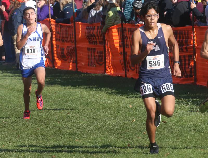 Newman's Ricardo Hernandez and Harvest Christian Academy's Caleb Gonzalez compete in the Class 1A State Cross Country race on Saturday, Nov. 4, 2023 at Detweiller Park in Peoria.