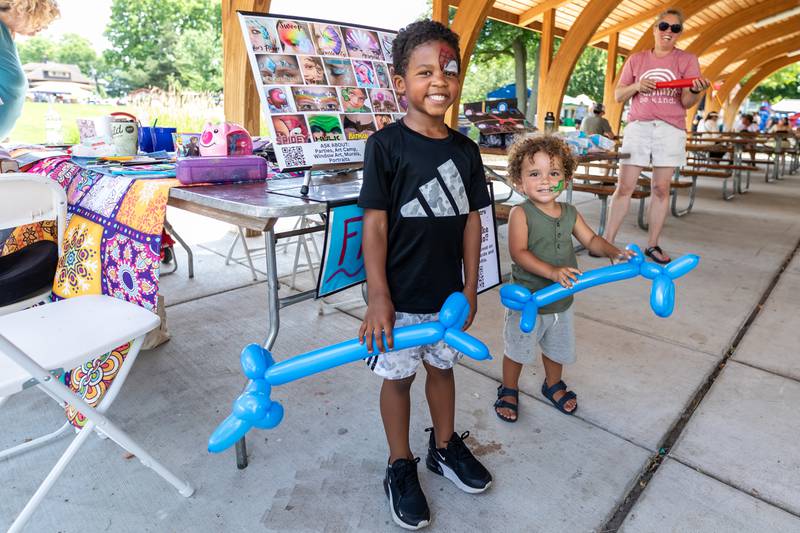 Plainfield residents Caleb O'Neil and Crew Wooten smile after getting a pair of balloon animals during Plainfield Fest on June 29, 2025.
