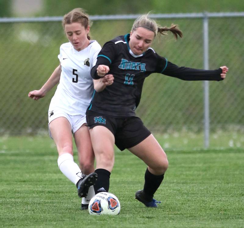 Woodstock North's Gracie Zankle tries to hold off Sycamore's Grace Parks during their IHSA Class 2A regional game Tuesday, May 17, 2022, at Burlington Central High School.