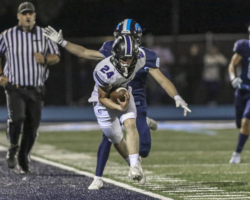 Downers Grove North's Zachary Surowiec (24) is pushed out of bounds during football game between Downers Grove North at Downers Grove South Friday, Sept 5, 2025  in Downers Grove.